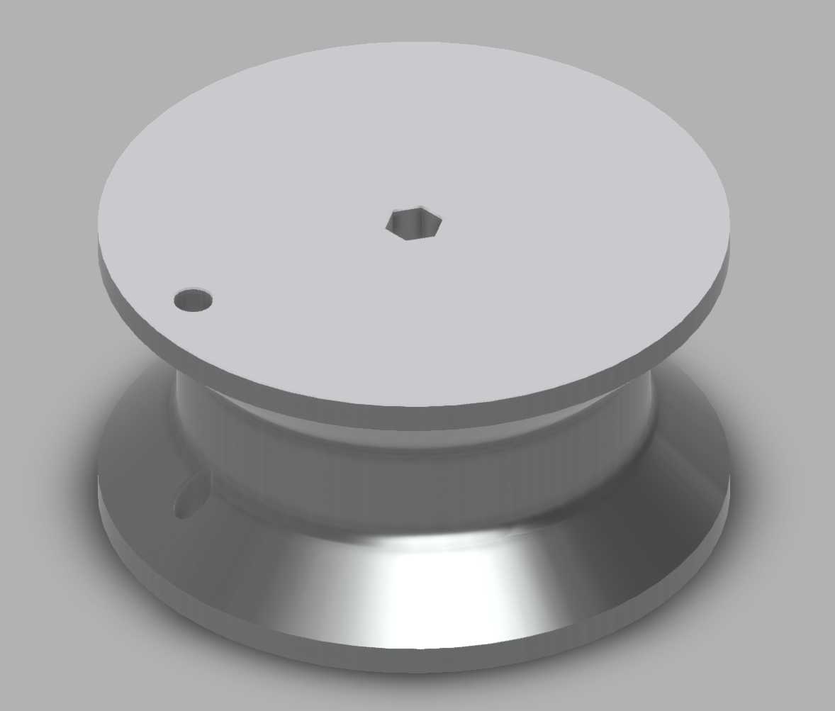 An image of a concave wheel, narrower in the middle than at the ends. There are two holes in the wheel: a hexagonal hole in the center which an axel is meant to pass through, and a circular hole that passes through where the eges of the wheel hang over the center. A string attaches at the smaller, circular hole