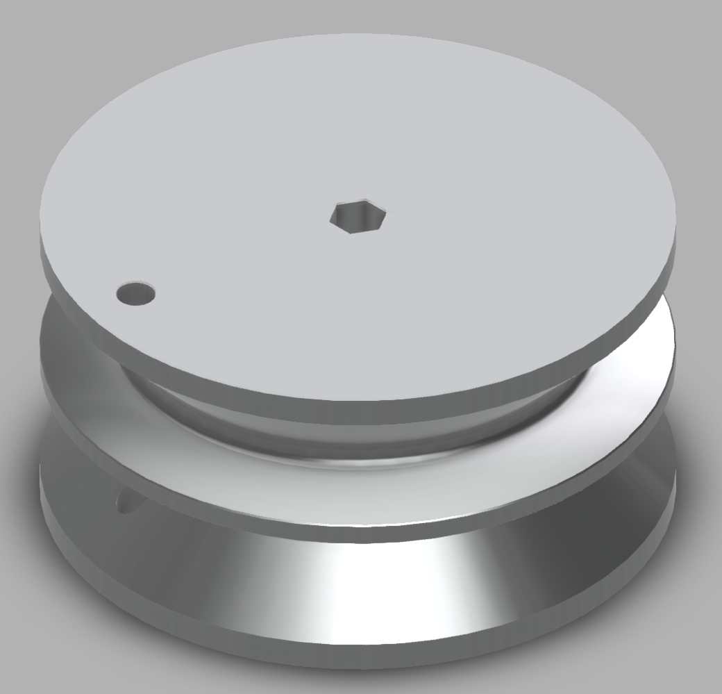 An image of a wheel with two grooves in it. The wheel has two holes: a hexagonal hole in the center that an axel passes through, and a smaller, cicular hole that a string can be attached to. The circular hole passes through the edges, which hang over the center of the wheel.